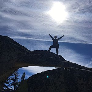 A hiker poses at the summit Yosemite National Park